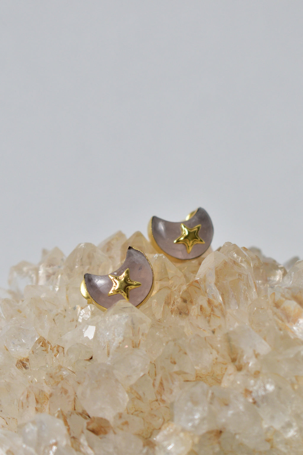 Pair of earrings with star designs on a crystal background