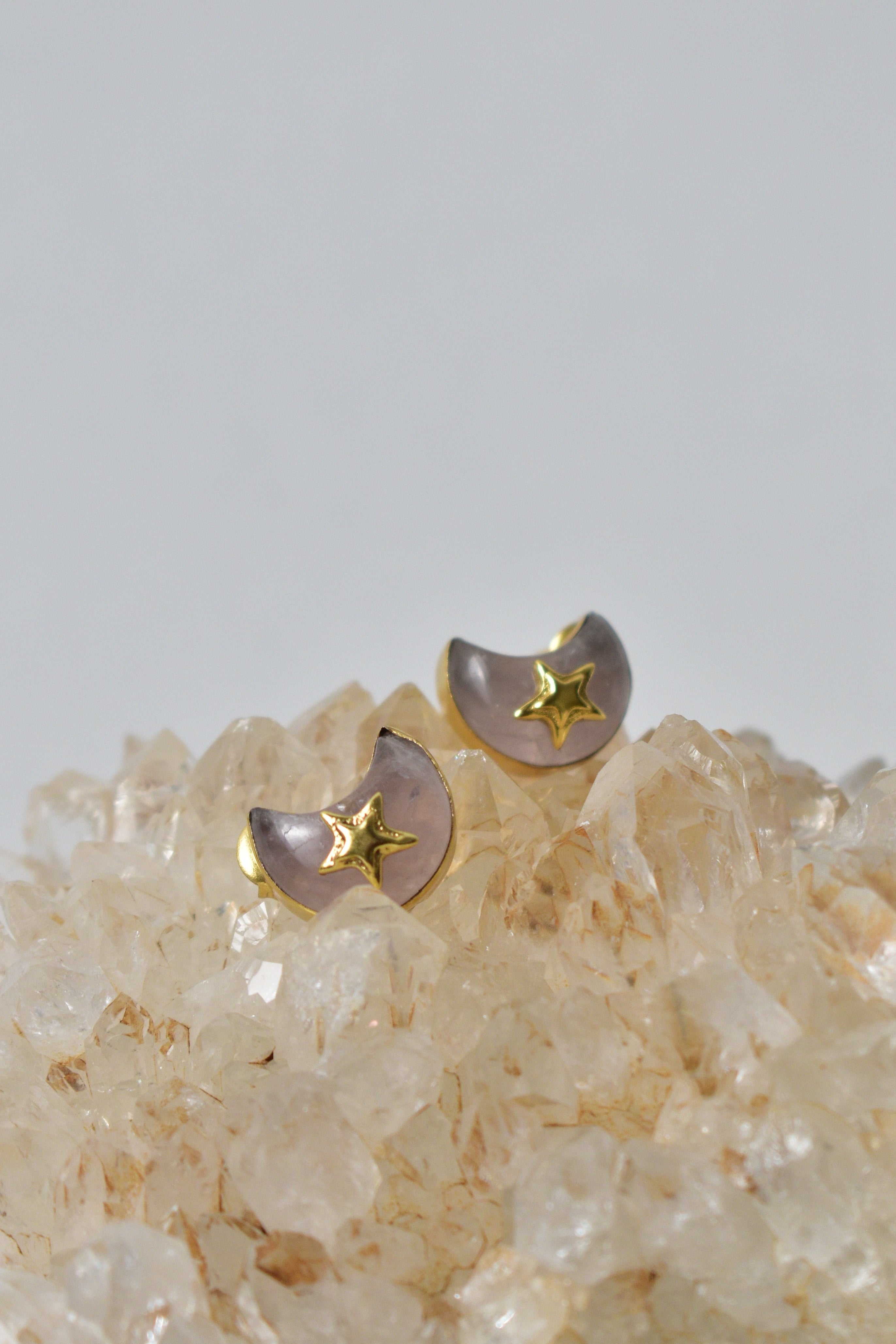 Pair of earrings with star designs on a crystal background