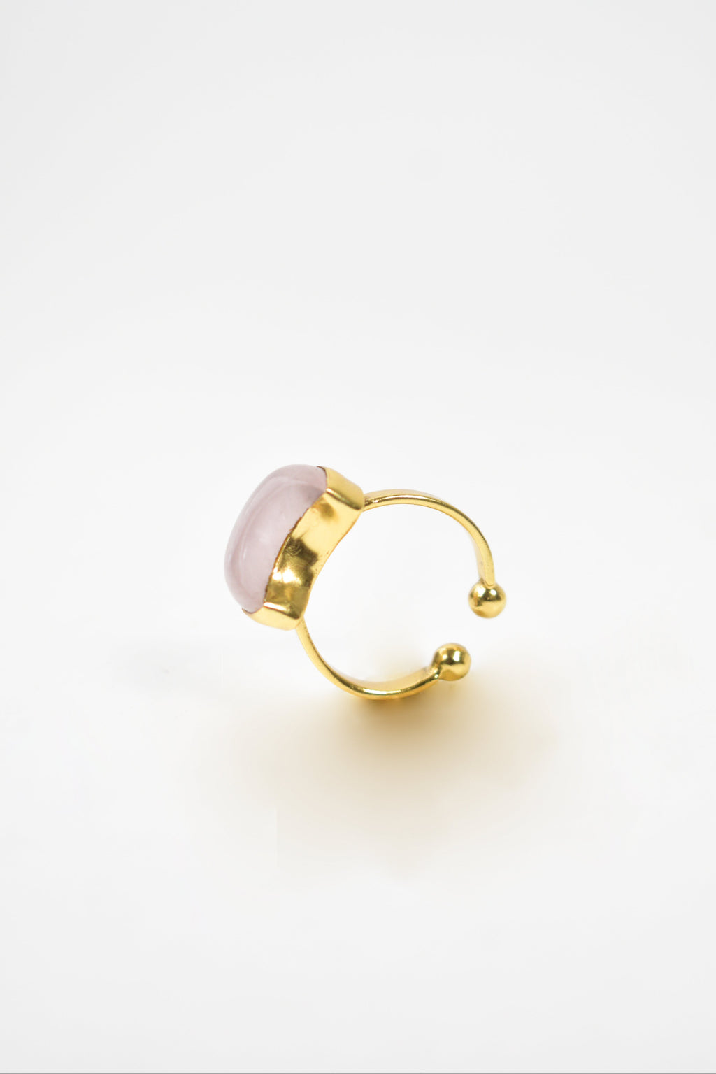 Gold hoop earring with pink gemstone on a white background Kokum jewels